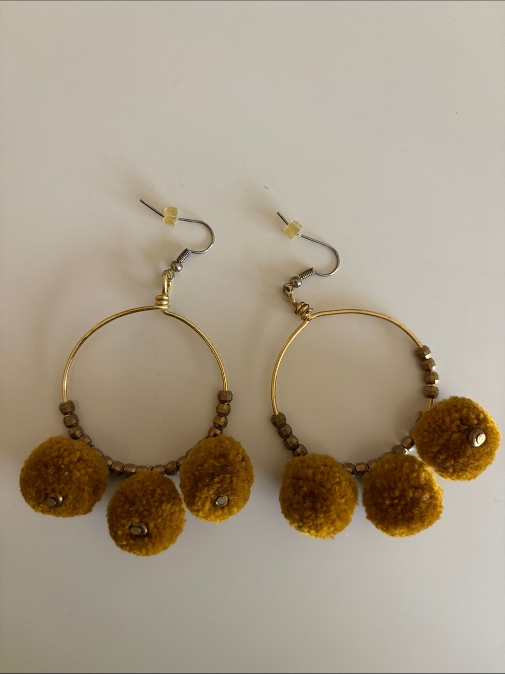 Noonday Collection Gold Hoop Earrings with Mustard Pom-Poms